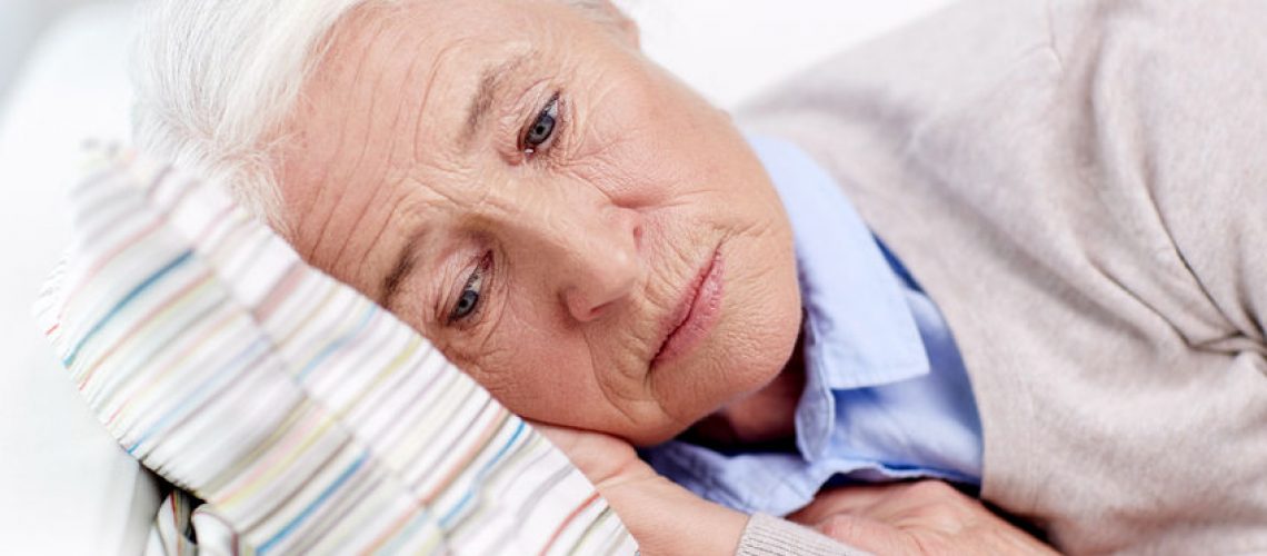 49529823 - age, sadness, trouble, problem and people concept - sad senior woman sleeping on pillow at home